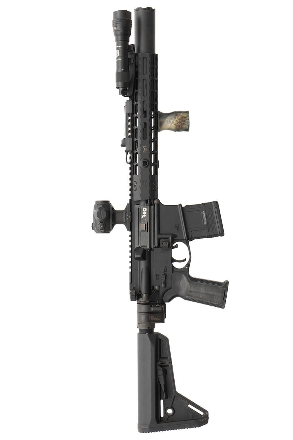 Photograph of a black home defense short-barreled rifle (SBR) displayed horizontally against a gray background with bold black text "HOME DEFENSE SBR" above. Rifle features adjustable stock, red dot sight, suppressor, flashlight, and vertical foregrip, highlighting tactical customization for close-quarters defense.