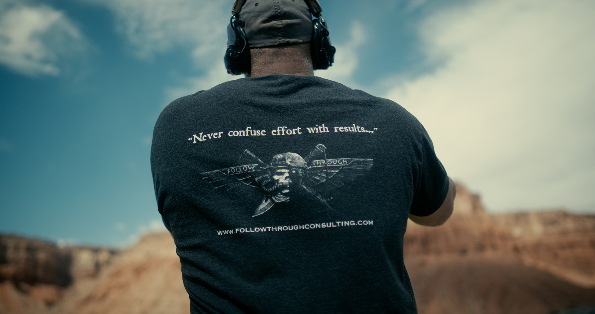 : Man wearing a Follow Through Consulting t-shirt with the quote Never confuse effort with results.<br />
Caption: Veteran instructor Buck Doyle’s core philosophy: "Never confuse effort with results."<br />
