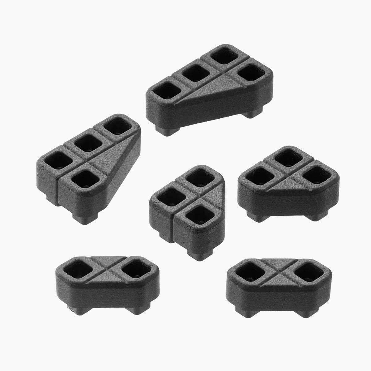 Studio layout of six black geometric EPP foam components from the Magpul DAKA Angled Block Kit.